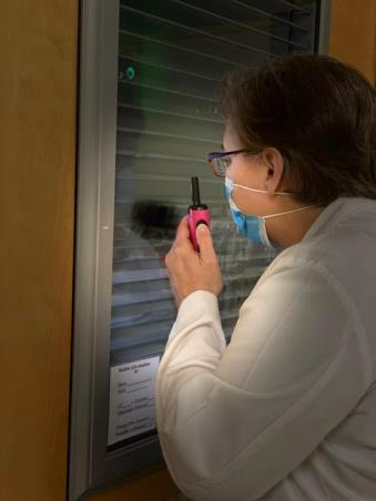 Doctor speaking through window